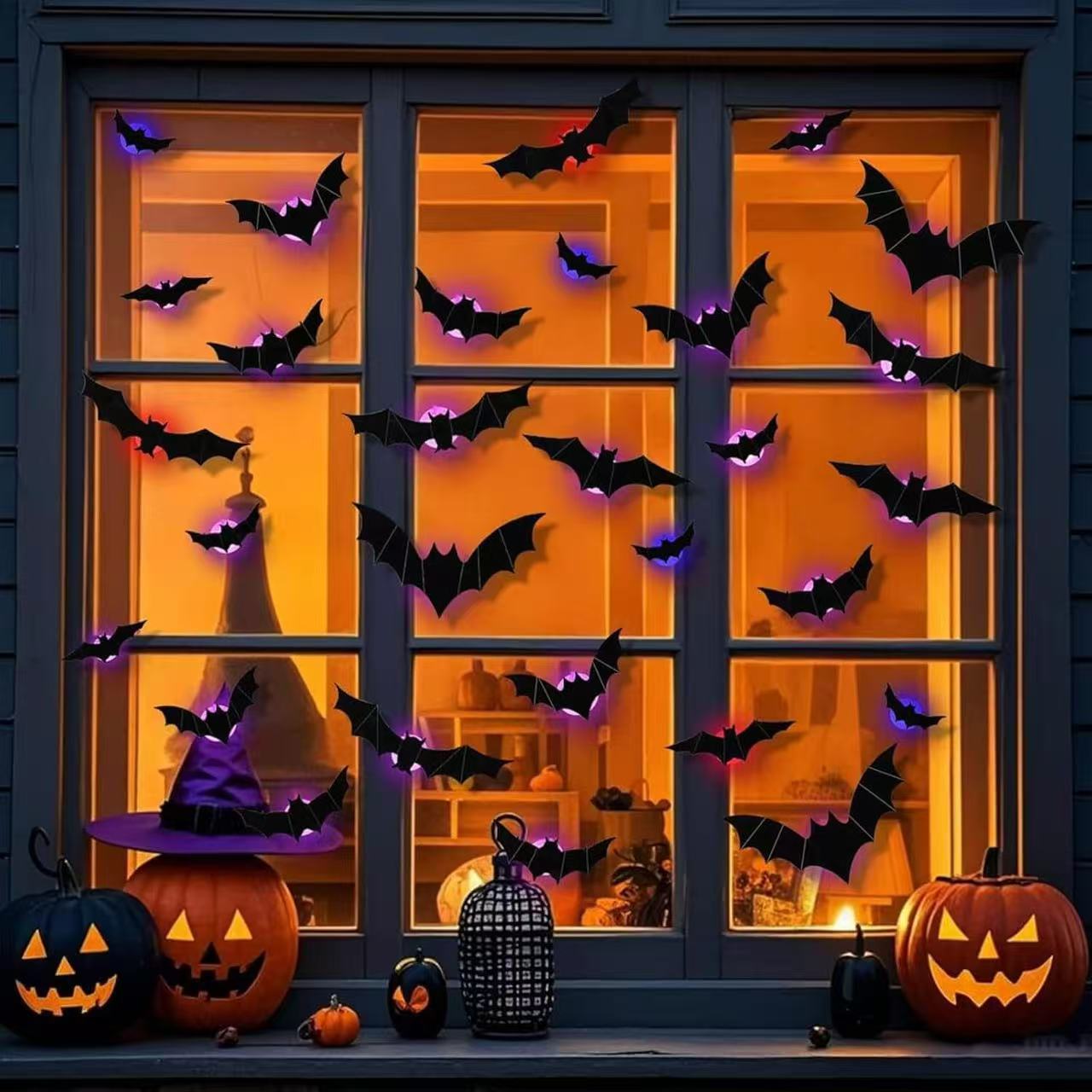 Glowing 3D LED bats and spiders decorating a Halloween window