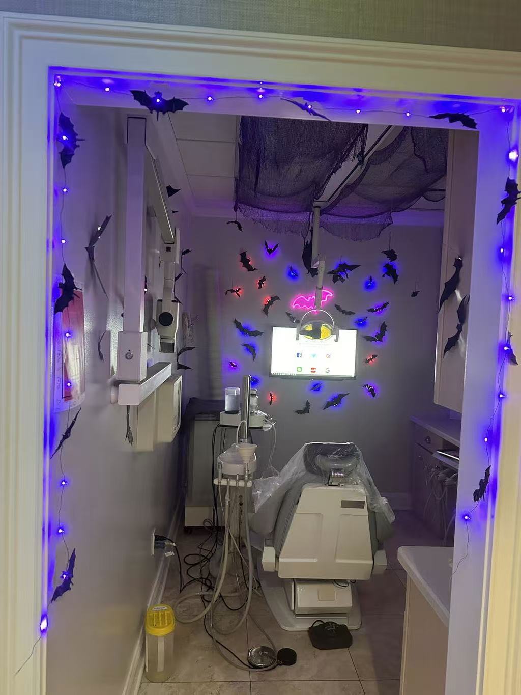 Customer Halloween room decorated with glowing bats and spiders