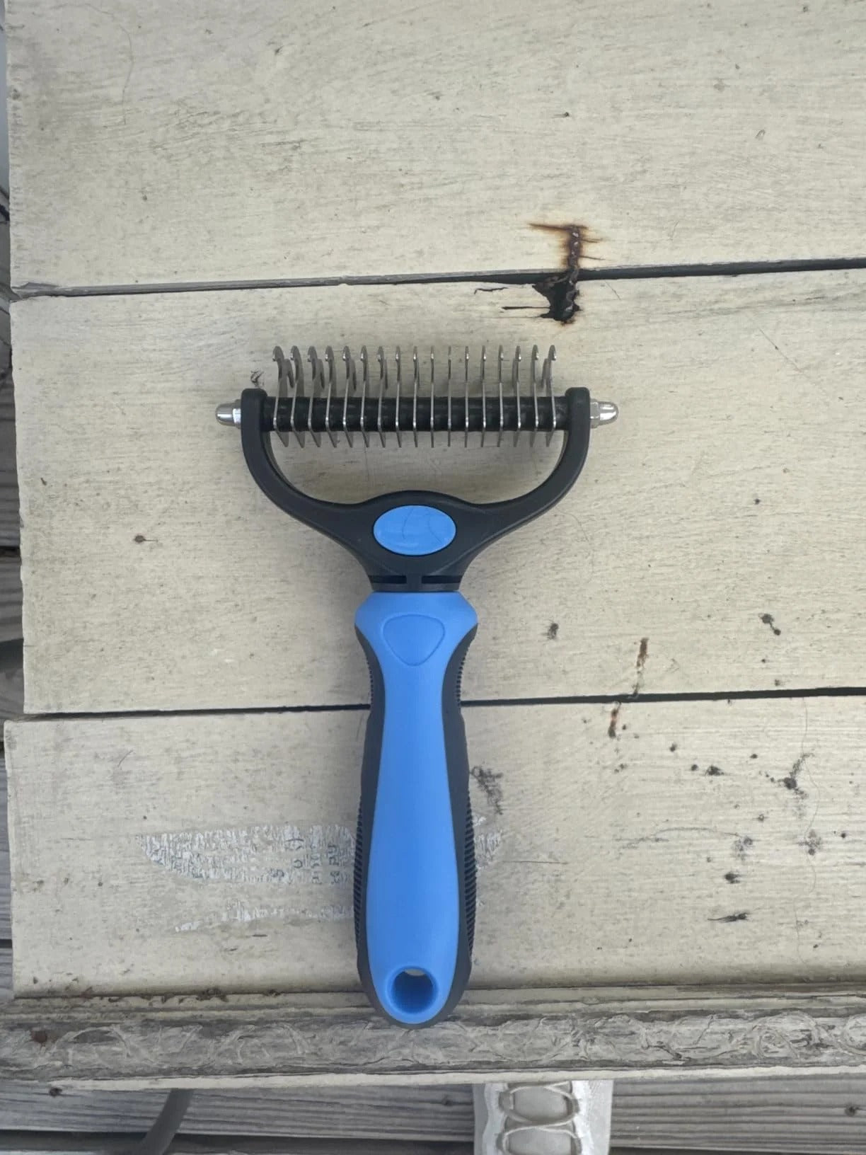 Blue double-sided grooming brush