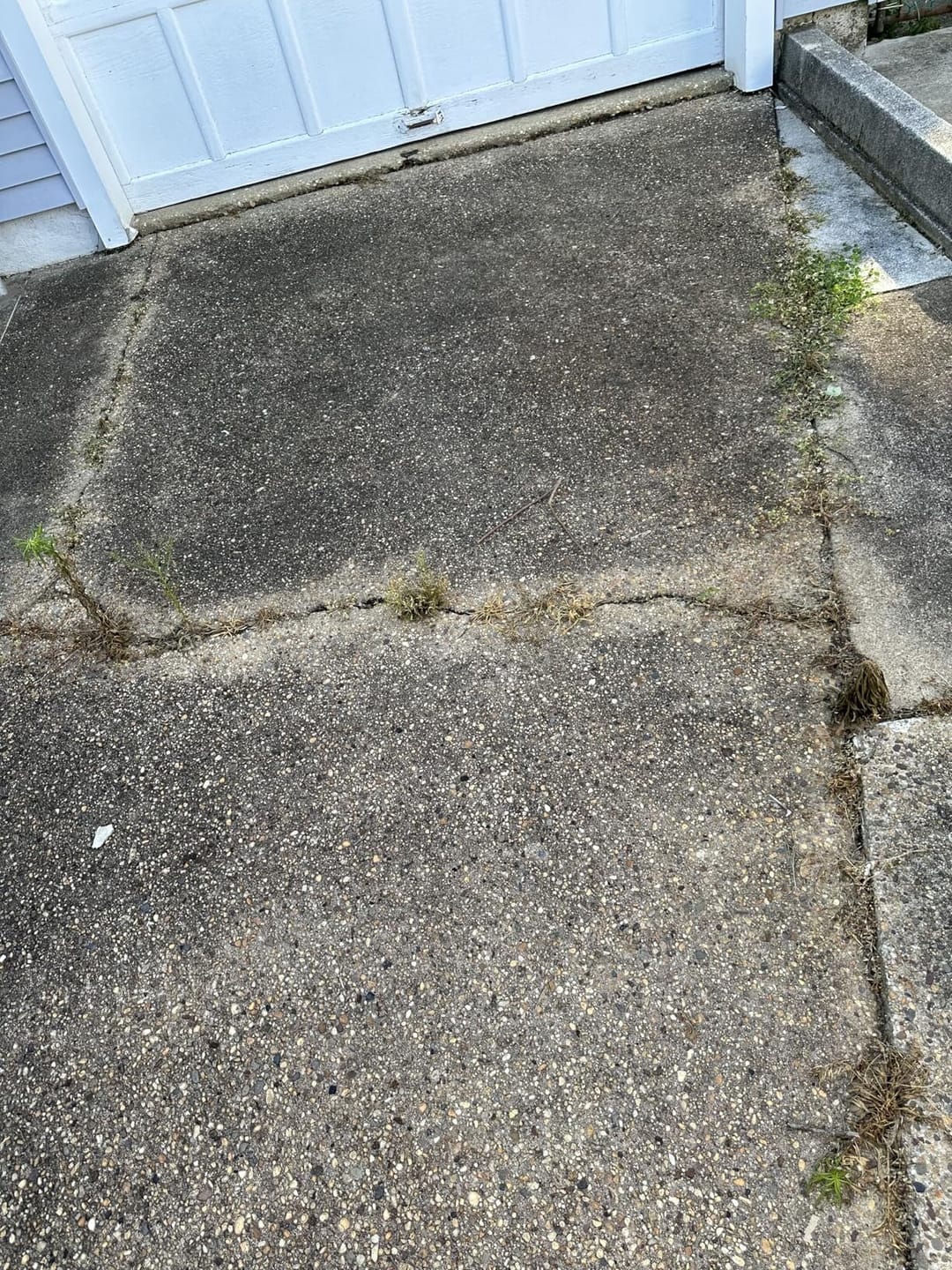 Driveway cracks after targeted weed treatment