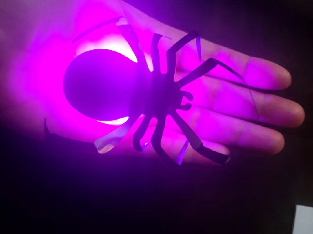Close-up customer photo of a glowing spider decoration
