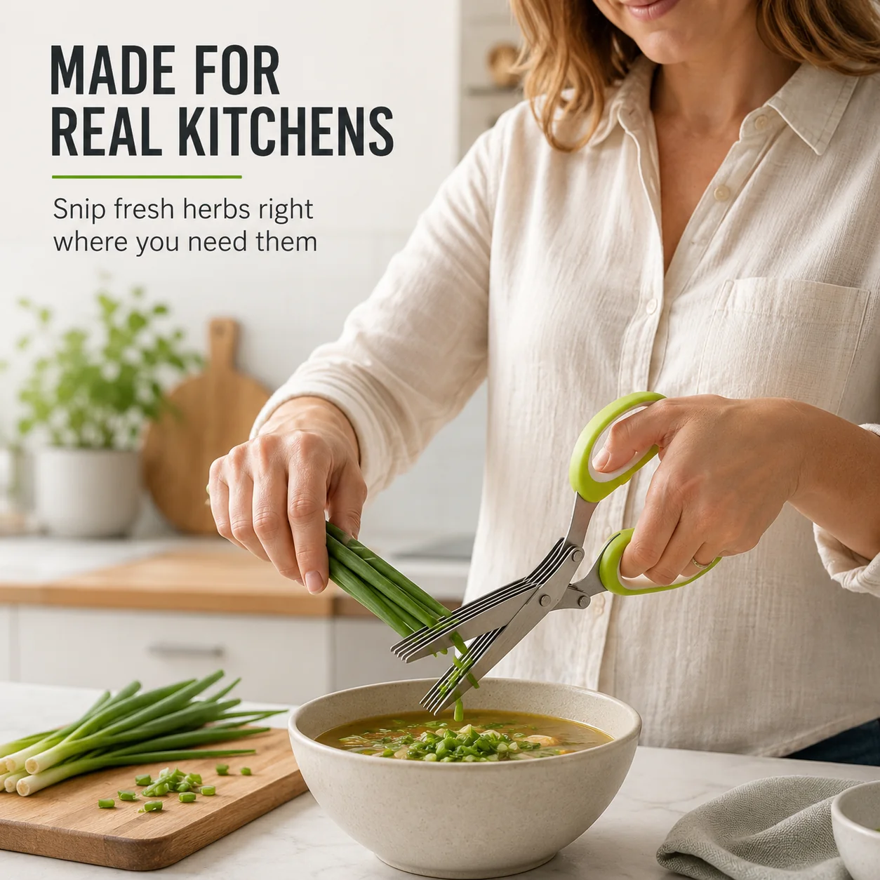 Five blade herb scissors cutting green onions over a bowl